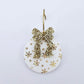 One Christmas Snowflake UV printed bauble dangle assembled on a 20mm hoop with a gold glitter bow 