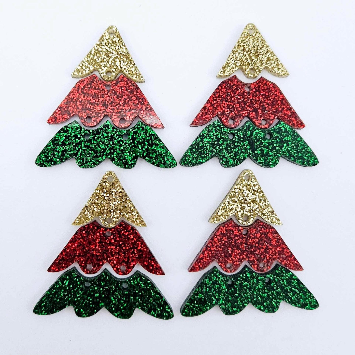 Two pairs of green, red and gold glitter three piece Christmas Tree dangle earring blanks laying flat