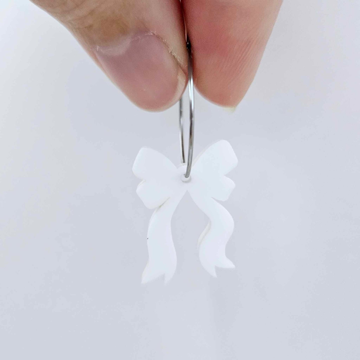 One white acrylic bow dangle earring blank assembled on a 20mm hoop