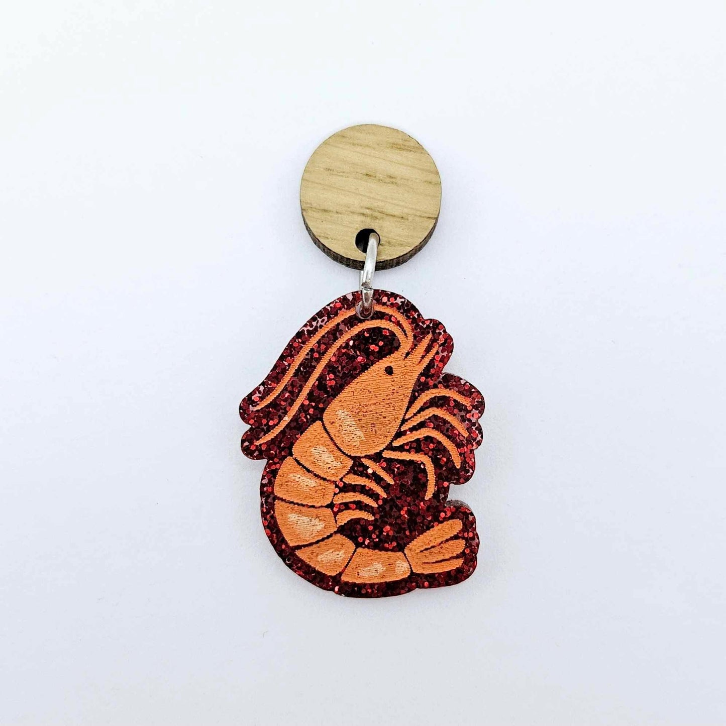 One red glitter acrylic prawn dangle earring blank assembled with a 14mm Oak Wood Topper, shown as a festive Australian Christmas earring