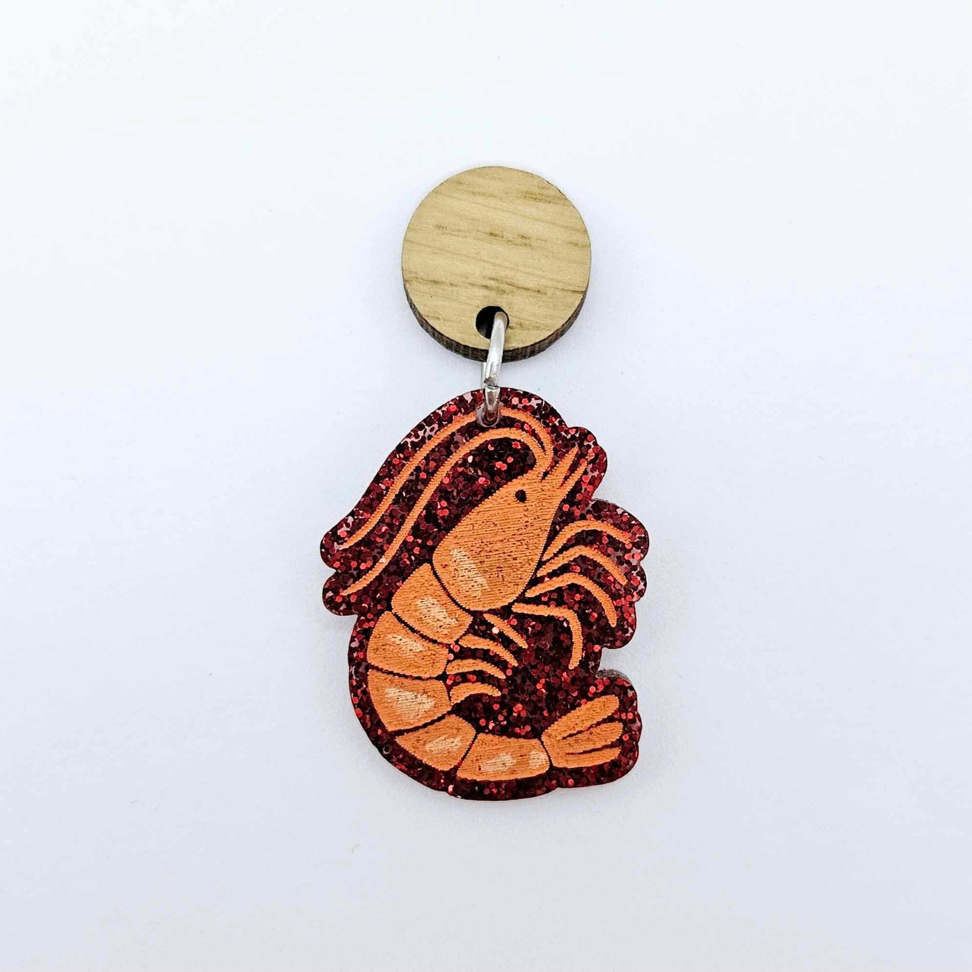 One red glitter acrylic prawn dangle earring blank assembled with a 14mm Oak Wood Topper, shown as a festive Australian Christmas earring