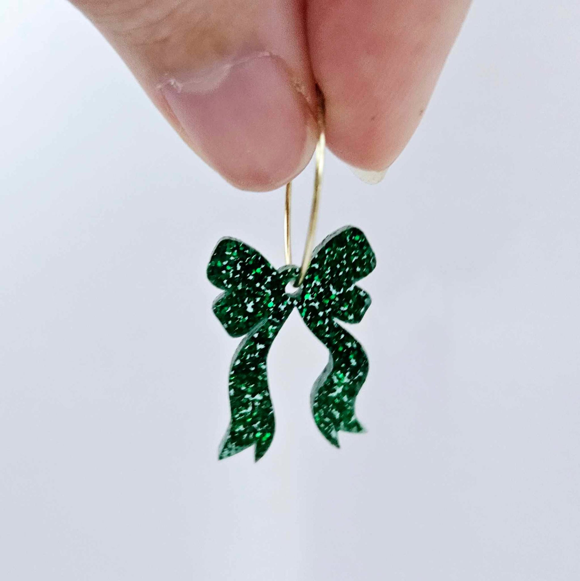 One green glitter acrylic bow dangle earring blank assembled on a 20mm hoop