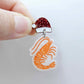 One white marble acrylic prawn dangle earring blank assembled with a Santa Hat Topper, shown as a festive Australian Christmas earring