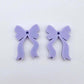  One pair of pastel purple acrylic bow dangle earring blanks laying flat