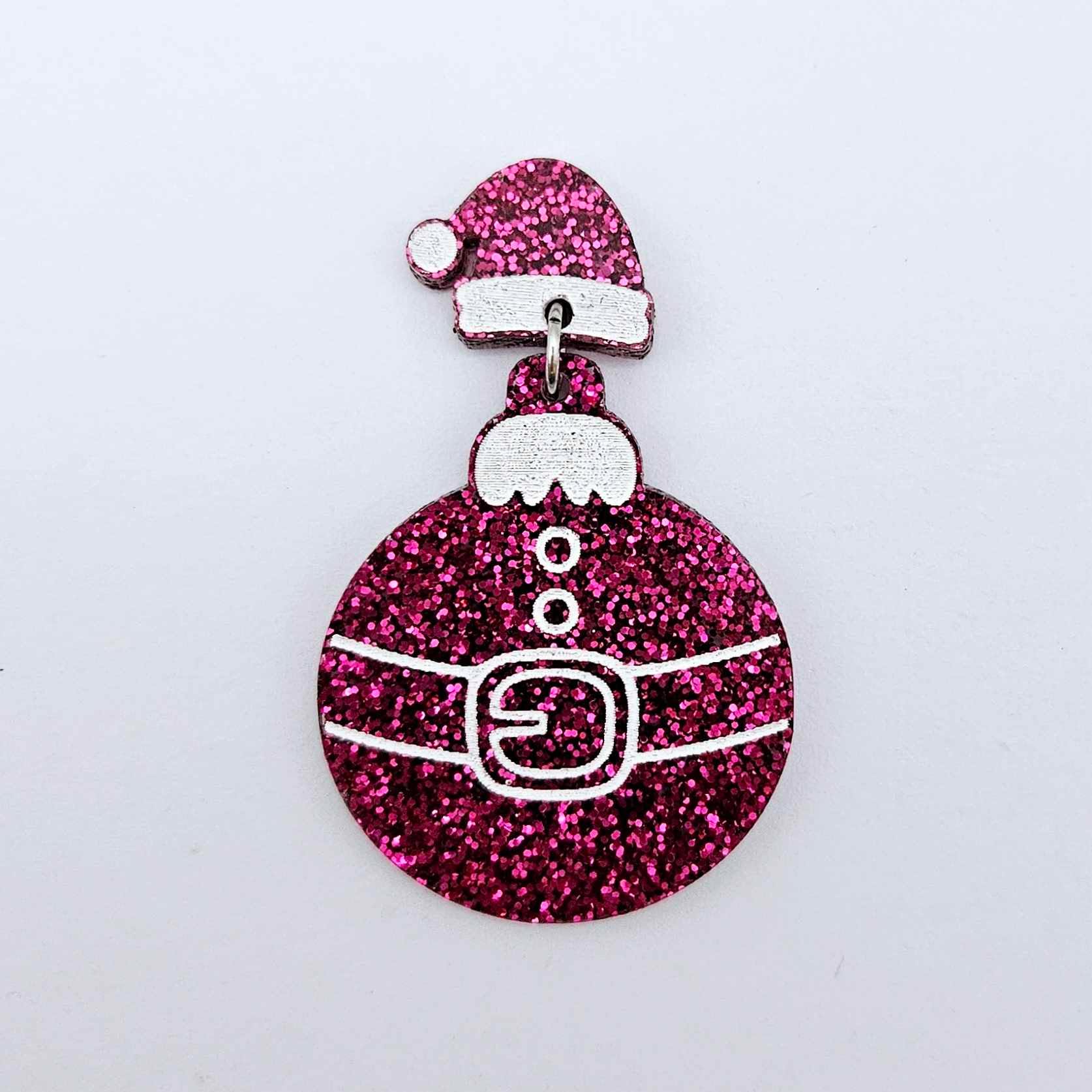 One hot pink glitter acrylic Santa hat topper attached to a Christmas Santa Bauble dangle, shown as a finished festive earring design