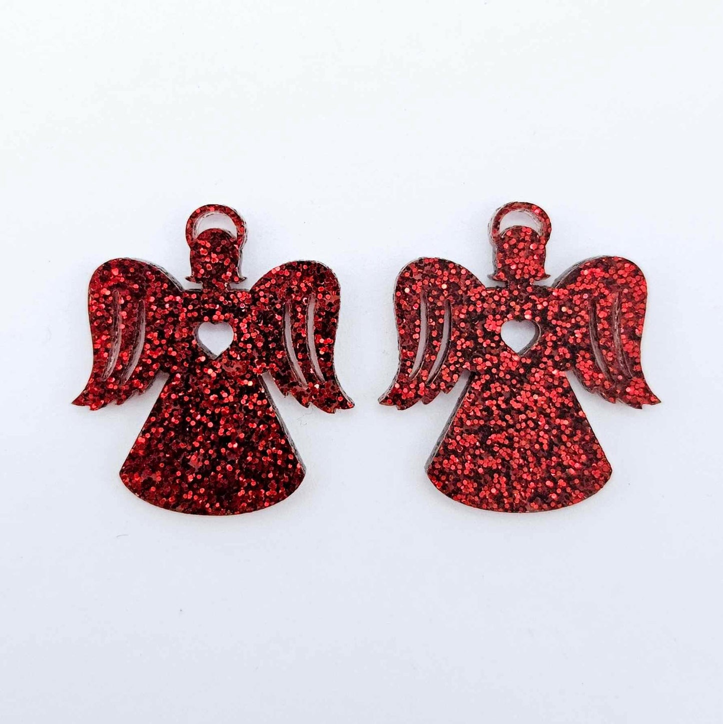 One pair of 32mm red glitter acrylic angel dangle earring blanks laying flat on a white background