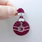 One hot pink glitter acrylic Santa hat topper attached to a Christmas Santa Bauble dangle, shown as a finished festive earring design