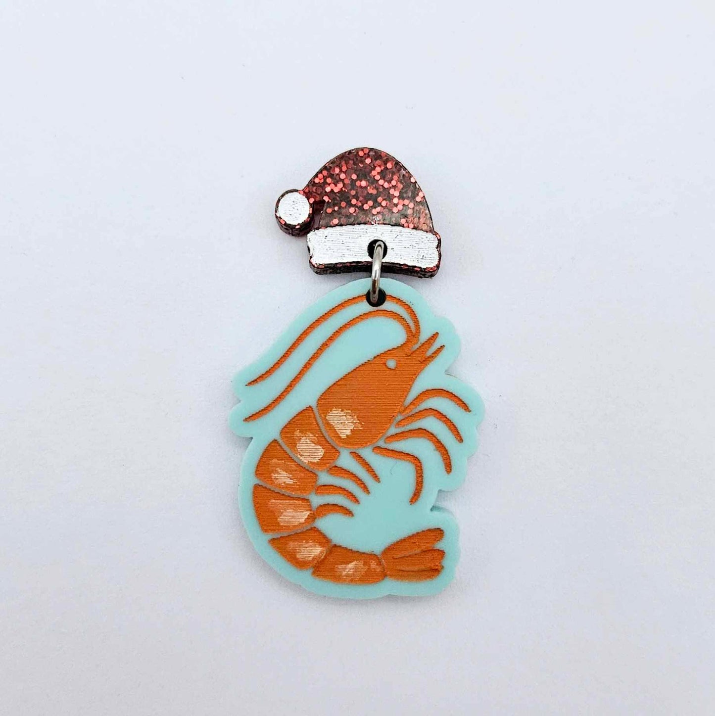 One pastel aqua acrylic prawn dangle earring blank assembled with a Santa Hat Topper, shown as a festive Australian Christmas earring