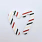 One pair of Stripy Christmas UV printed acrylic candy cane dangle earring blanks laying flat 