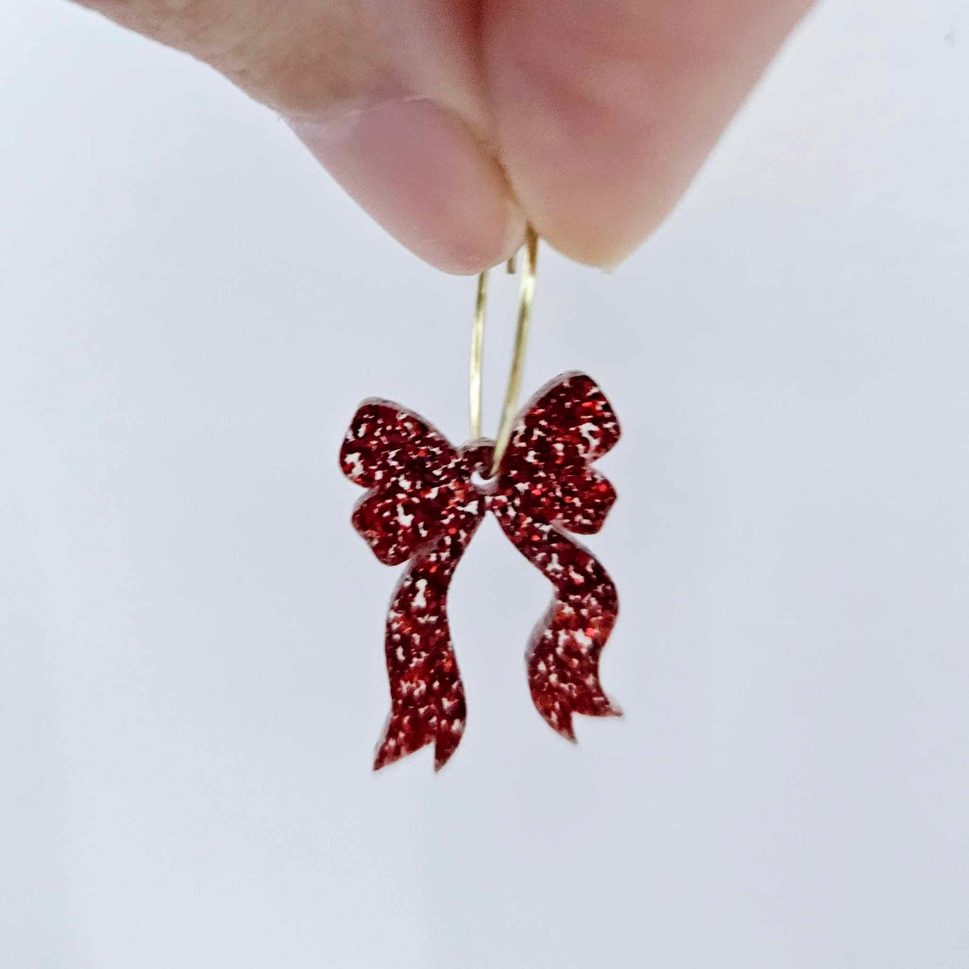One red glitter acrylic bow dangle earring blank assembled on a 20mm hoop