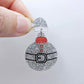 One silver glitter acrylic Santa hat topper attached to a Christmas Santa Bauble dangle, shown as a finished festive earring design