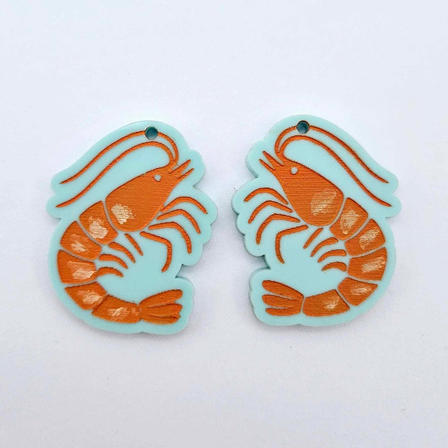 One pair of pastel aqua acrylic prawn dangle erring blanks paint filled with orange and white details