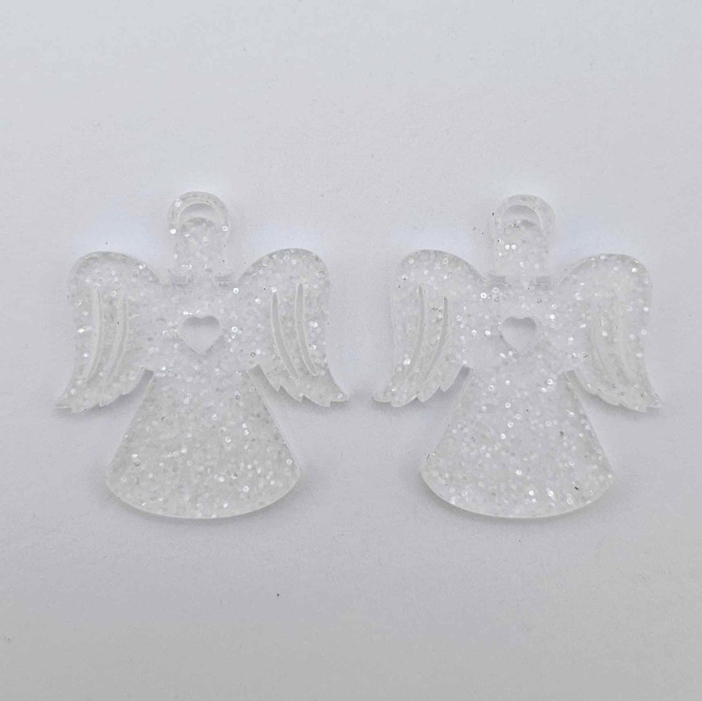 One pair of 32mm fairy dust glitter acrylic angel dangle earring blanks laying flat on a white background