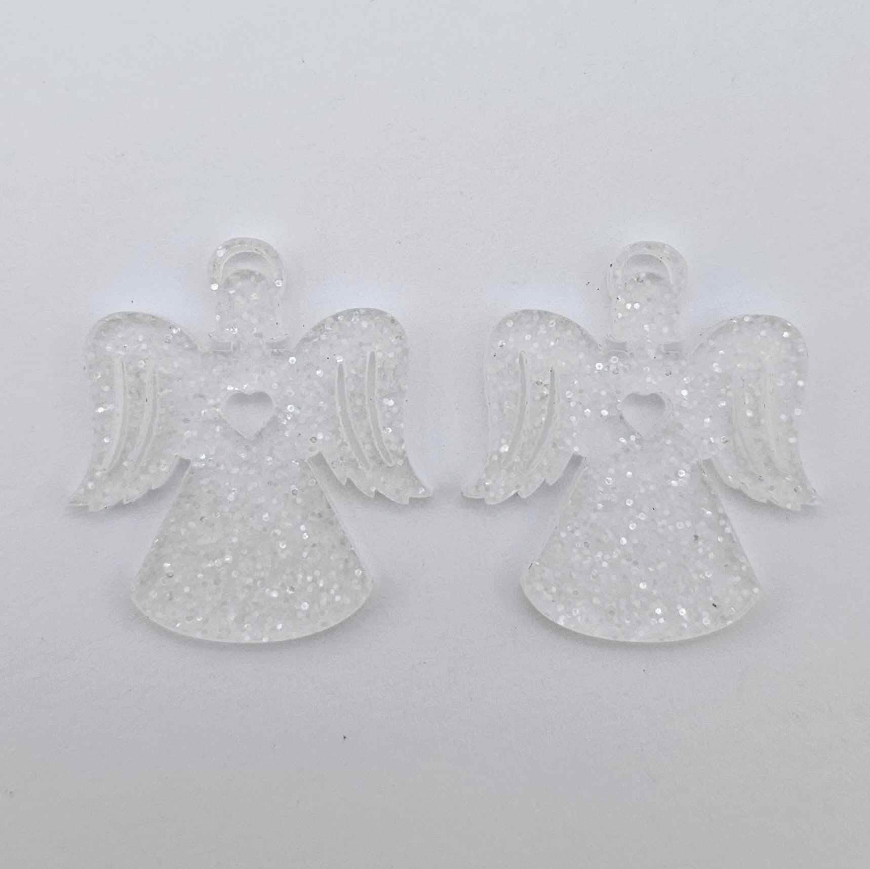 One pair of 32mm fairy dust glitter acrylic angel dangle earring blanks laying flat on a white background