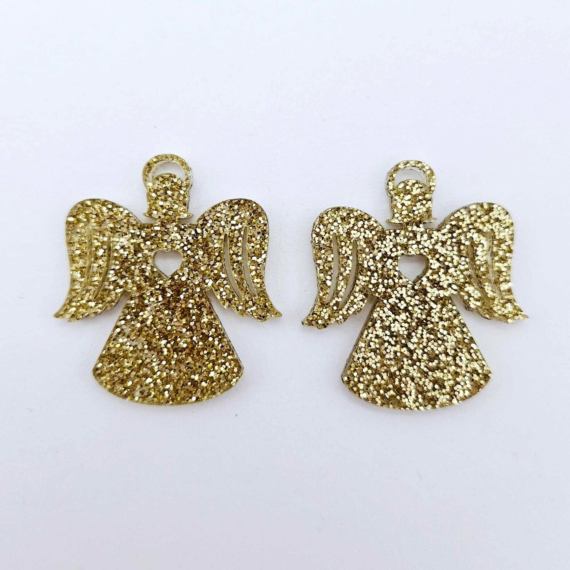 One pair of 32mm gold glitter acrylic angel dangle earring blanks laying flat on a white background