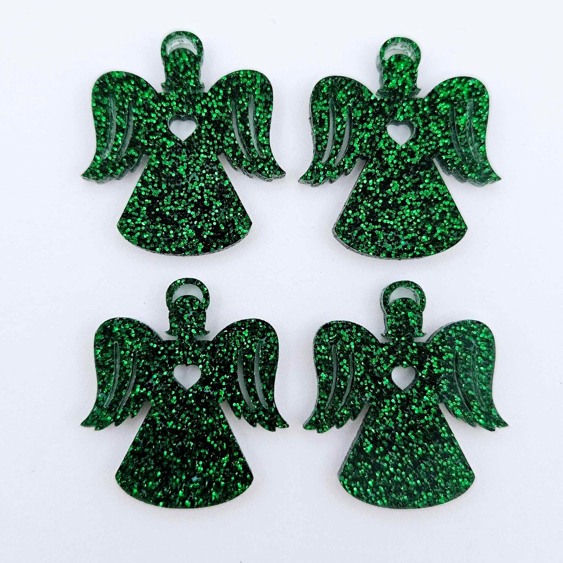 Two pairs of 32mm green glitter acrylic angel dangle earring blanks laying flat on a white background