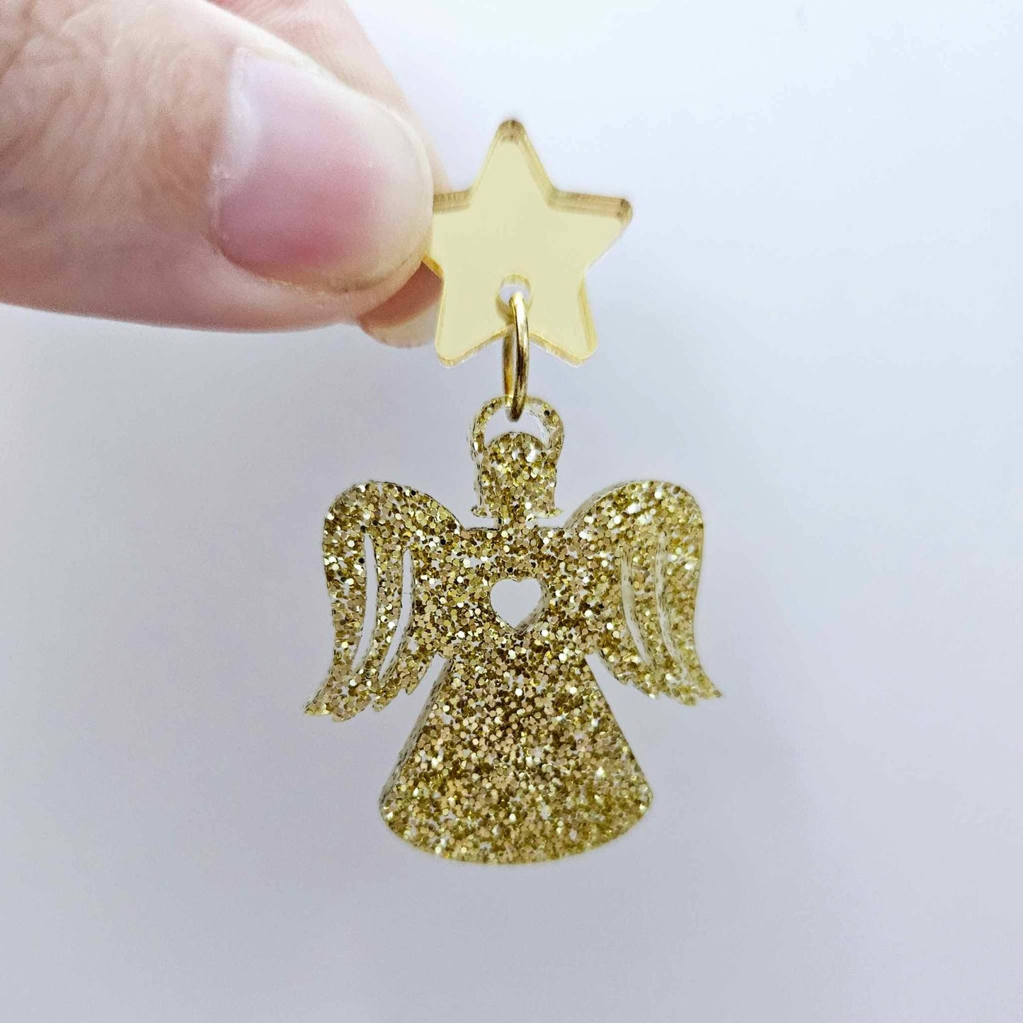 One 32mm gold glitter acrylic angel dangle earring blank assembled with a 16mm gold mirror star topper, shown as a finished earring 
