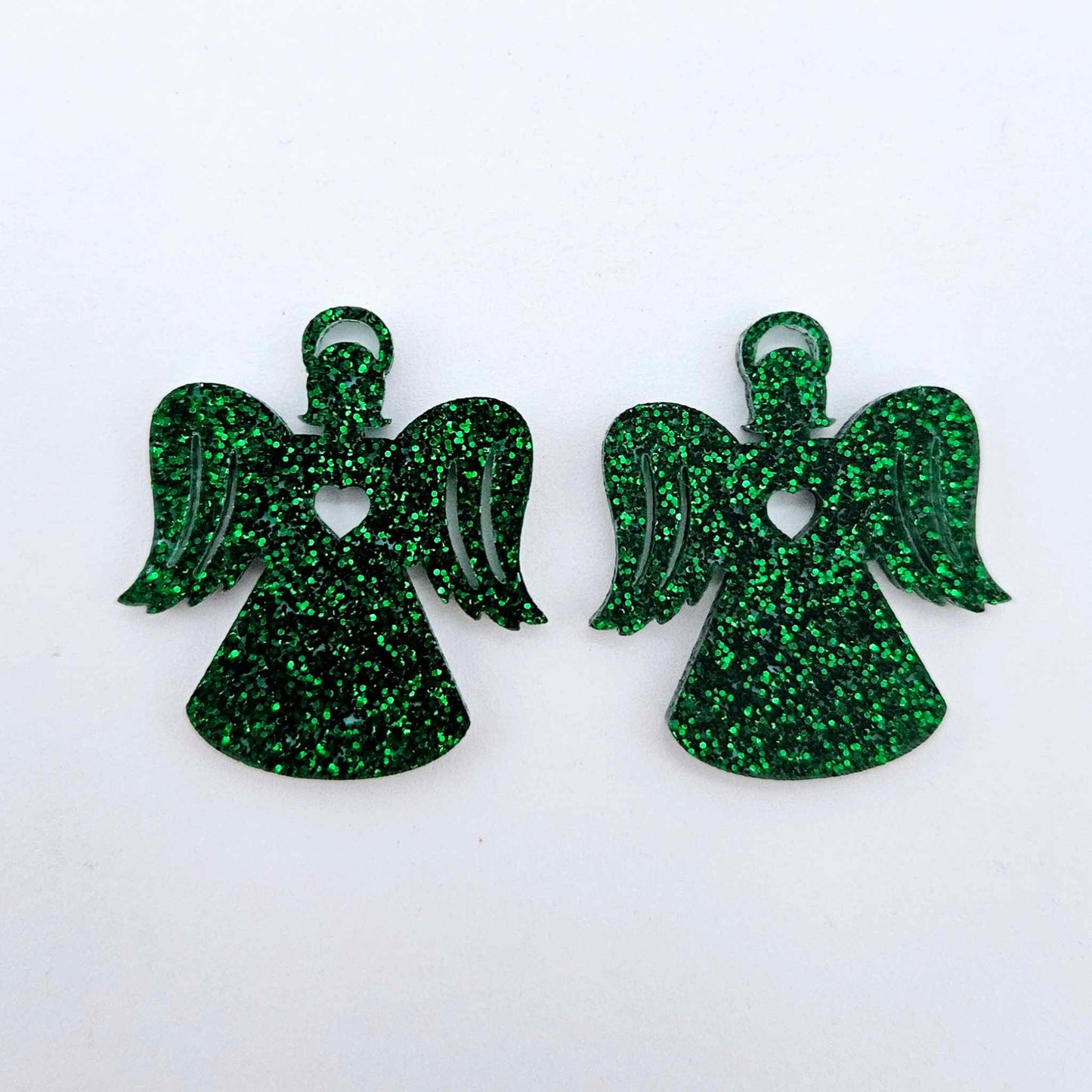 One pair of 32mm green glitter acrylic angel dangle earring blanks laying flat on a white background