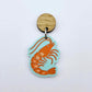 One pastel aqua acrylic prawn dangle earring blank assembled with a 14mm Oak Wood Topper, shown as a festive Australian Christmas earring