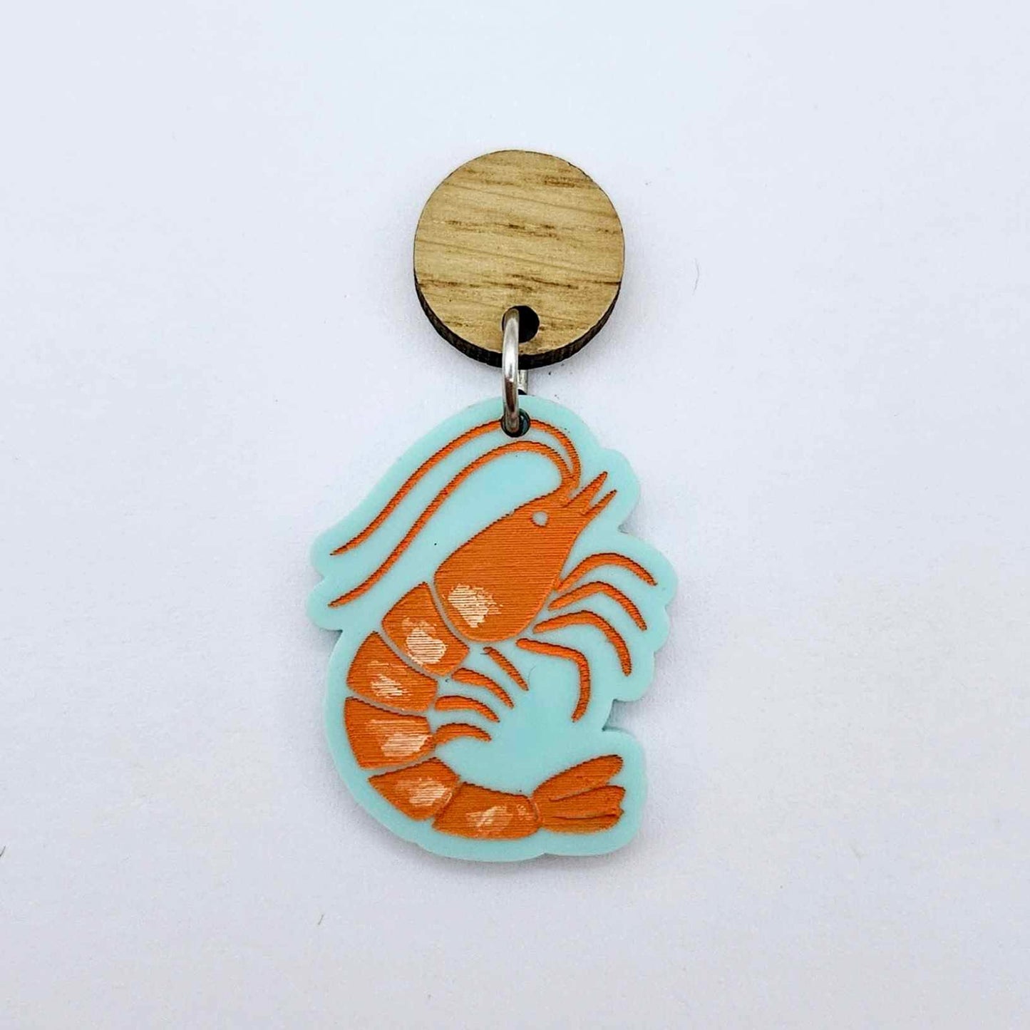One pastel aqua acrylic prawn dangle earring blank assembled with a 14mm Oak Wood Topper, shown as a festive Australian Christmas earring