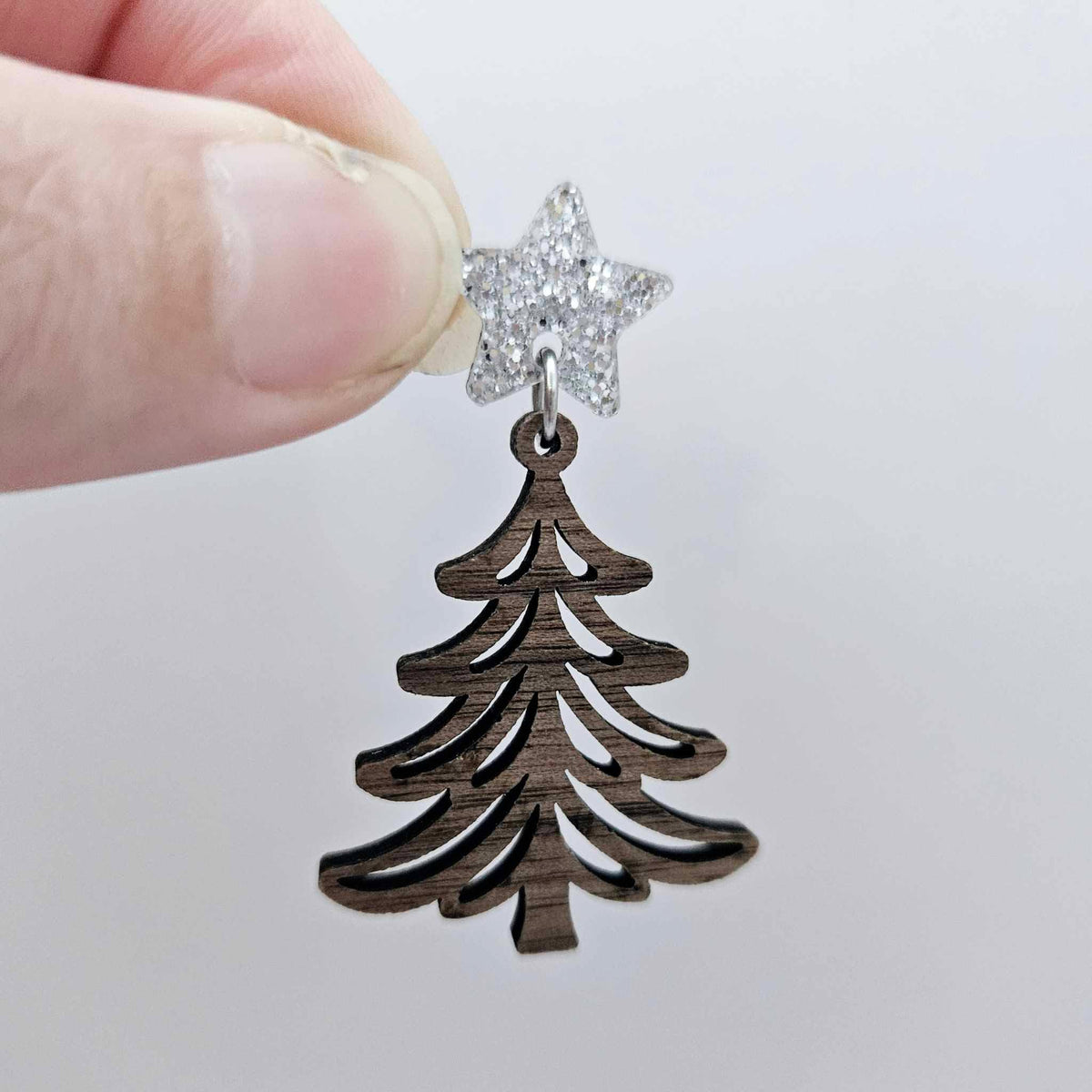 One 14mm silver glitter star topper paired with a walnut Christmas tree dangle to show how it can be used in a festive earring design