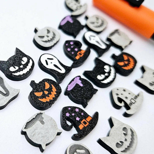 A mixed selection of black glitter acrylic Halloween stud earring blanks featuring Spooky Cats, Witch’s Cauldrons, Jack-O’-Lanterns, Spooky Face Masks and Witch’s Hats laying flat