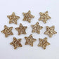 Five pairs of 14mm rose gold glitter acrylic star earring toppers laying flat