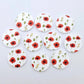 Multiple 20mm Poppy UV printed stud earring blanks featuring detailed poppy blooms and green foliage on white acrylic laying flat.