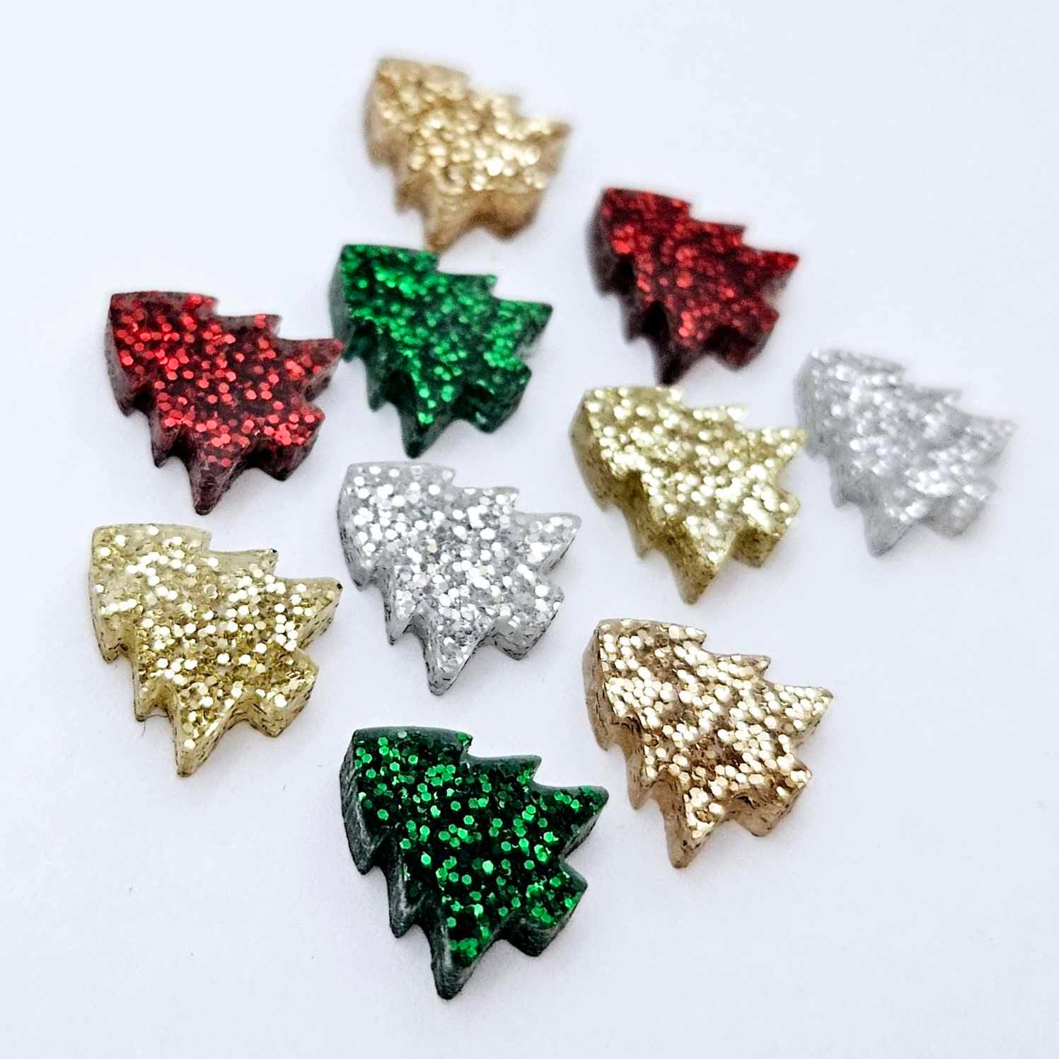 12mm mini Christmas tree stud earring blanks in five traditional fine glitter colours laying flat