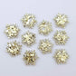 Five pairs of 16mm chunky gold glitter acrylic snowflake stud earring blanks laying flat.