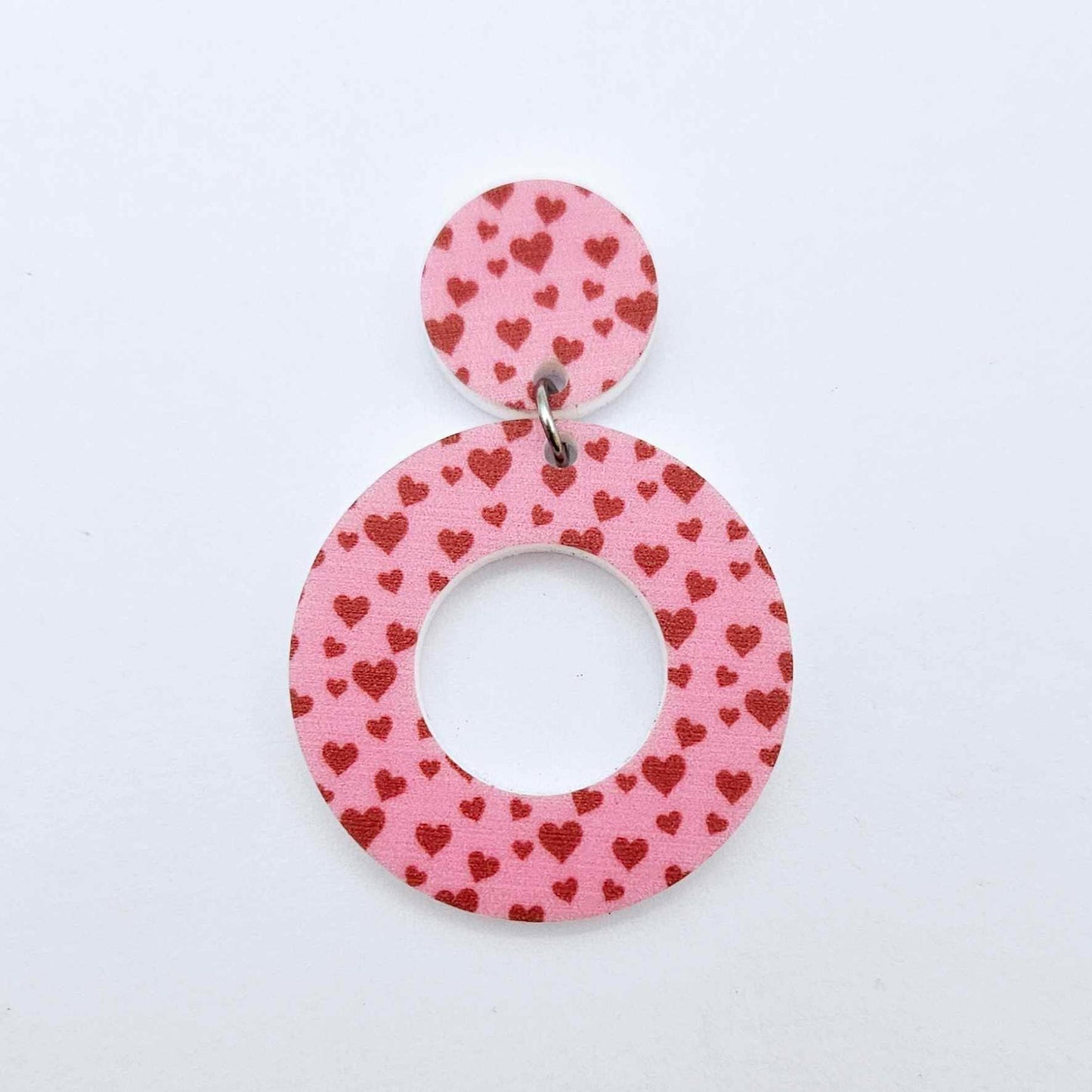One 33mm Pink & Red Hearts UV printed acrylic mini hoop dangle assembled with its matching included topper to show the completed earring design.