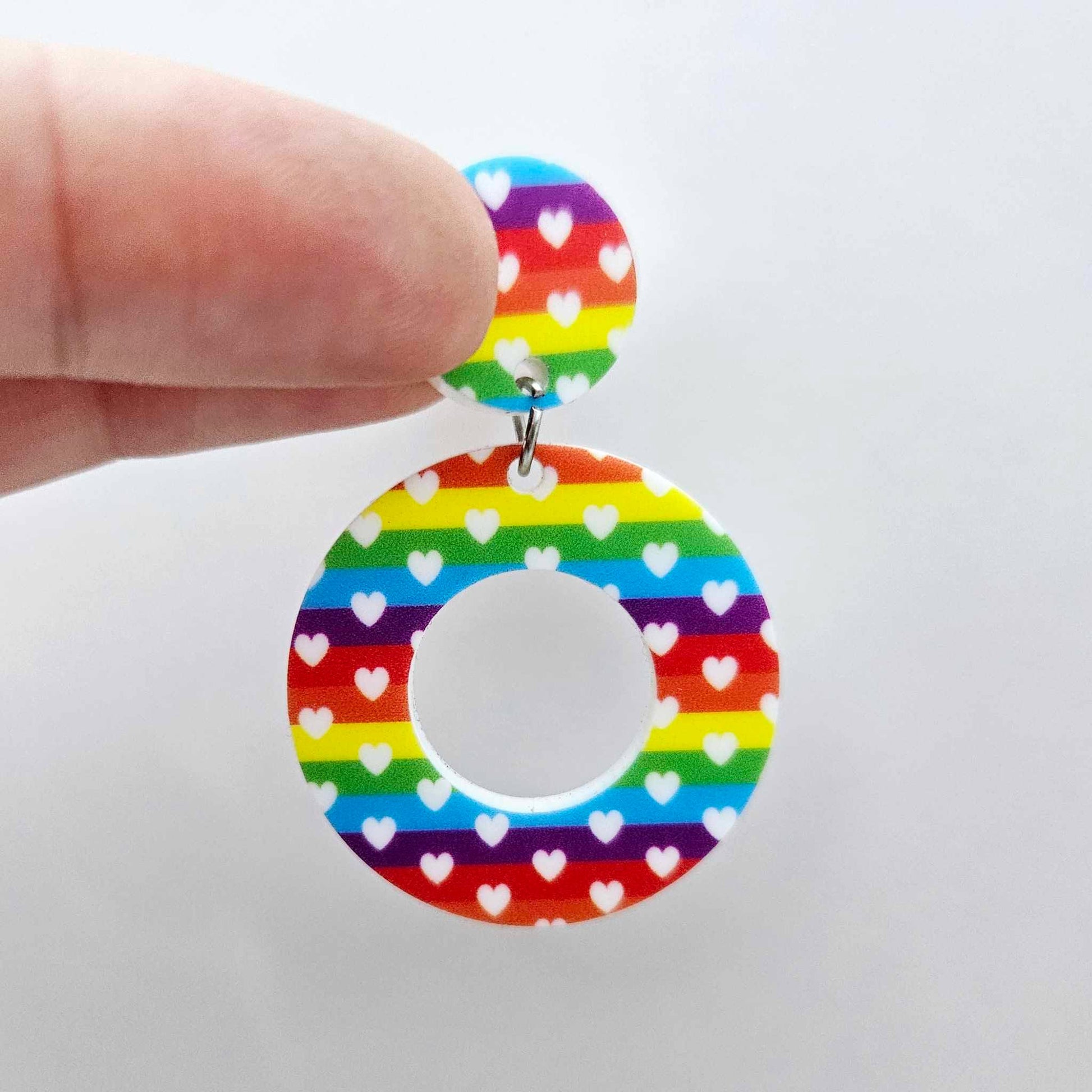 One 33mm Rainbow Love UV printed acrylic mini hoop dangle assembled with its included matching topper to show the completed earring design.