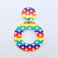 One 33mm Rainbow Love UV printed acrylic mini hoop dangle assembled with its included matching topper to show the completed earring design.