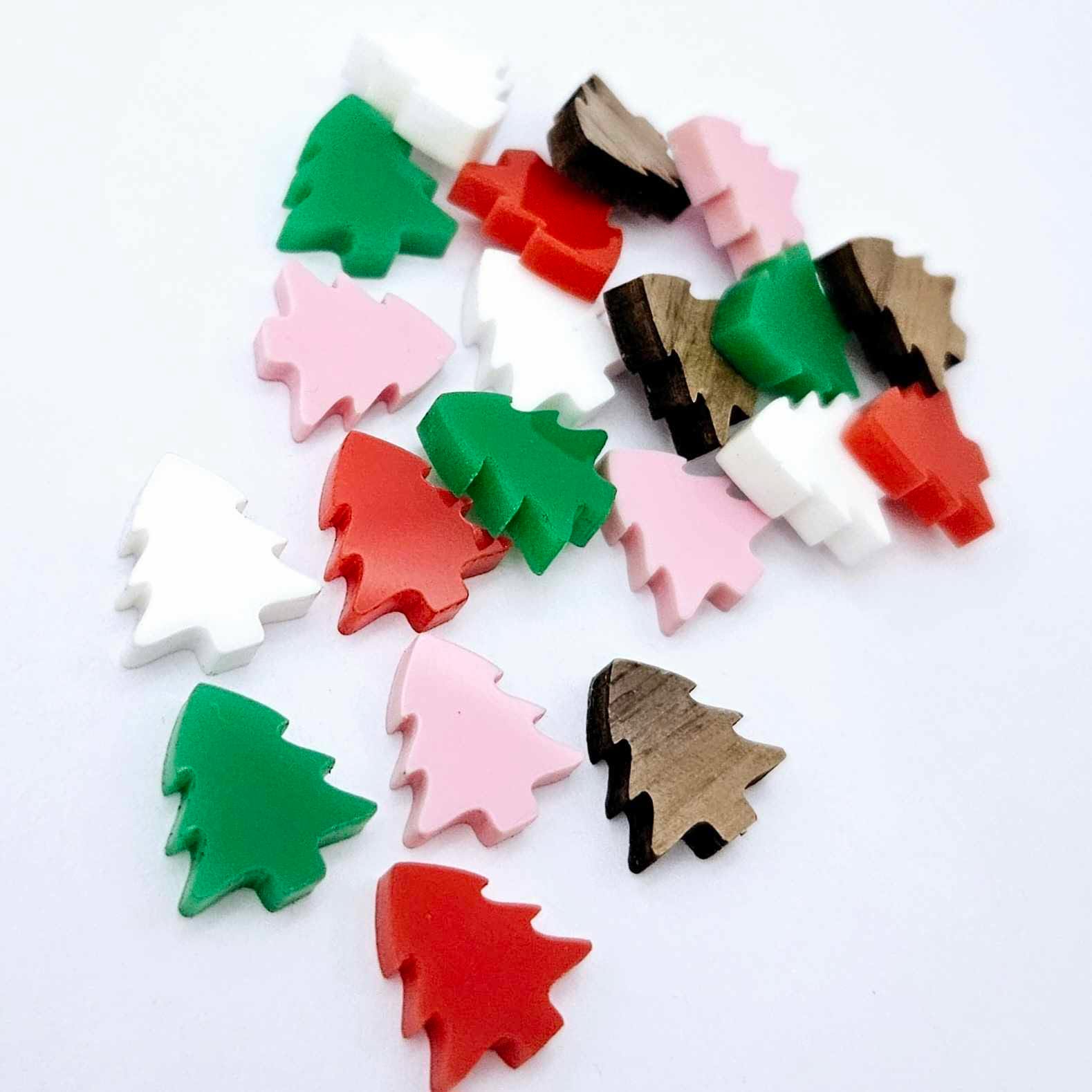 20 pieces of 12mm Christmas tree stud earring blanks in red, green, white and pastel pink solid acrylic and walnut veneer piled together.