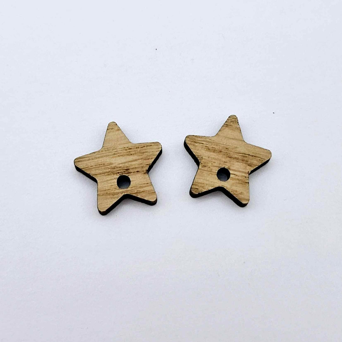 16mm oak veneer star earring toppers, one pair laid flat.