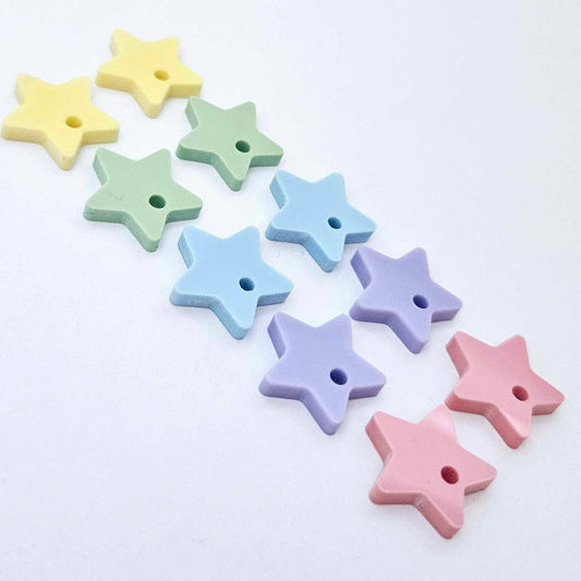 16mm pastel star acrylic earring toppers in pink, purple, blue, mint and yellow, with one pair of each colour laid flat together.