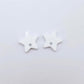 16mm white acrylic star earring toppers, one pair laid flat.