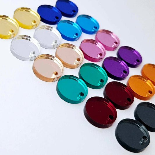 One pair of each 14mm mirror acrylic earring topper in 11 colours laying flat, including gold, silver, rose gold, green, red, gun metal grey, dark blue, light blue, pink, purple and orange mirror.