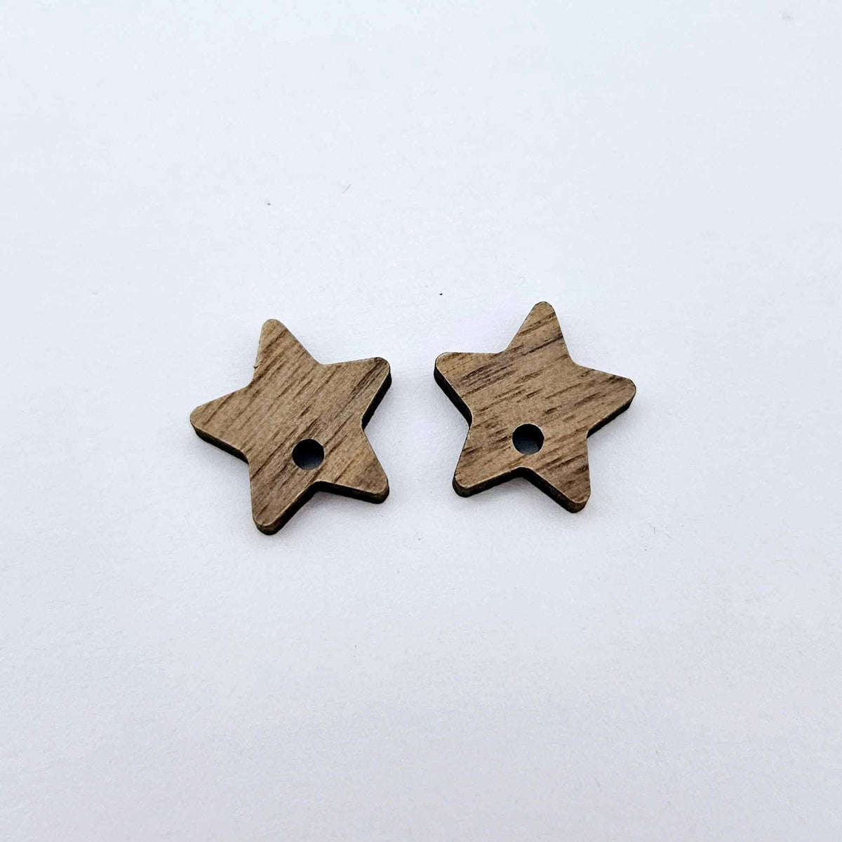 16mm walnut veneer star earring toppers, one pair laid flat.