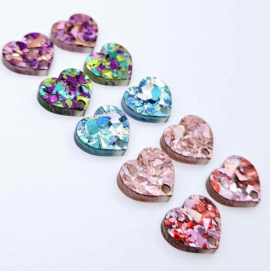 14mm chunky glitter acrylic heart earring toppers in Chunky Love, holographic rose gold, aqua, peacock and unicorn, with one pair of each colour laid flat together.