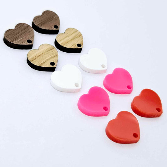 14mm heart earring toppers in solid red, hot pink, white, oak and walnut, with one pair of each colour and finish laid flat together.