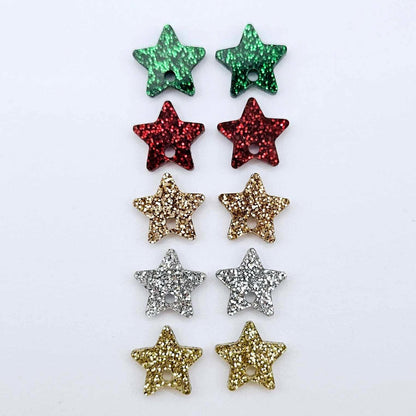 A selection of 14mm fine glitter acrylic star earring toppers in gold, silver, green, red and rose gold glitter laying flat