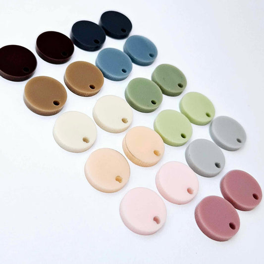 14mm earthy solid acrylic circle earring toppers in dusty rose, strawberry milkshake, peach, cream, iced coffee, chocolate brown, grey, eucalyptus, olive green, blue stone and navy denim, with the colour range laid flat together.
