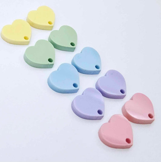 14mm pastel acrylic heart earring toppers in pink, purple, blue, mint and yellow, with one pair of each colour laid flat together.