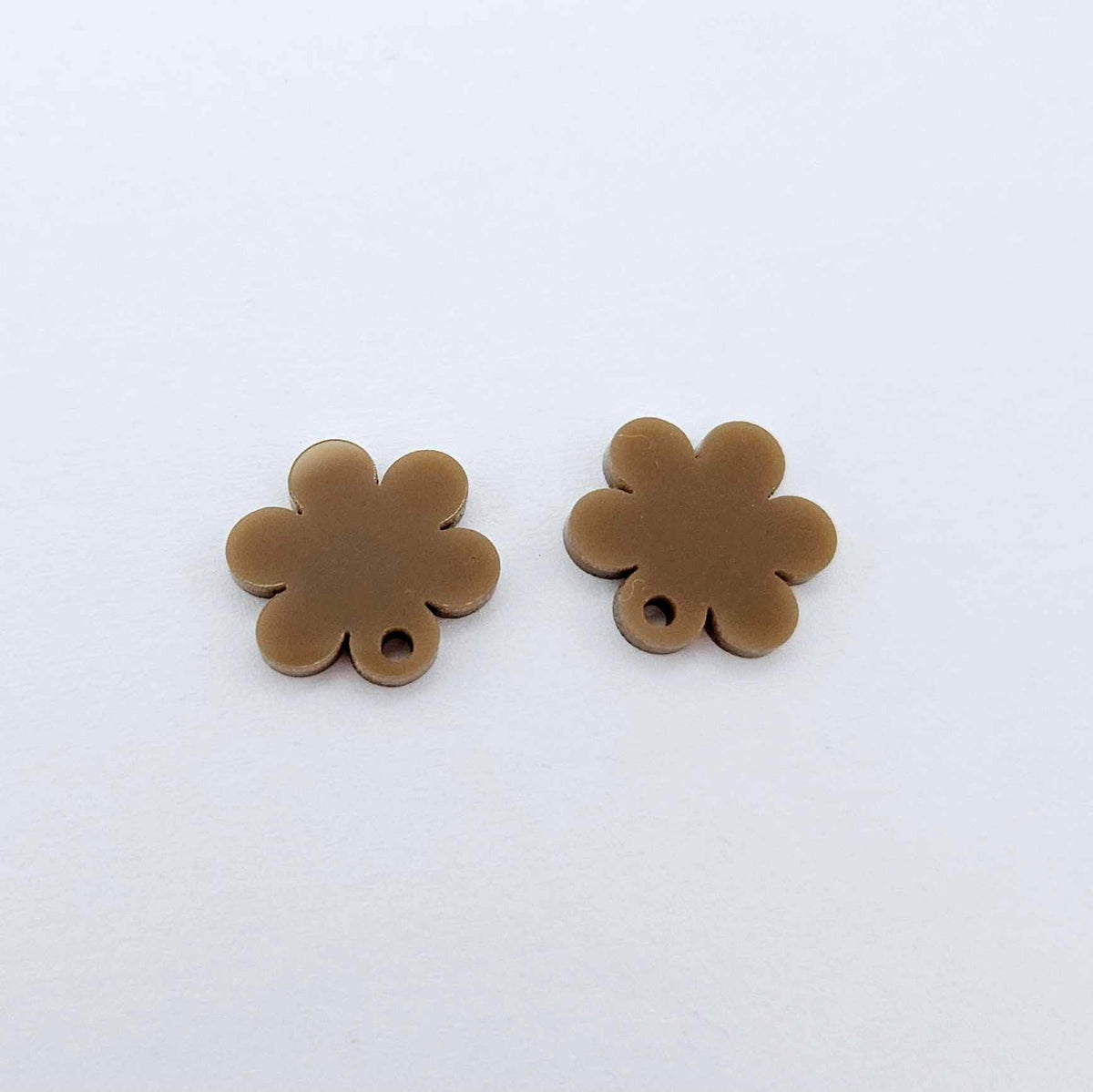 One pair of 14mm iced coffee acrylic flower earring topper blanks laying flat.