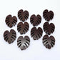 17mm chocolate brown acrylic monstera leaf stud earring blanks laid flat together.