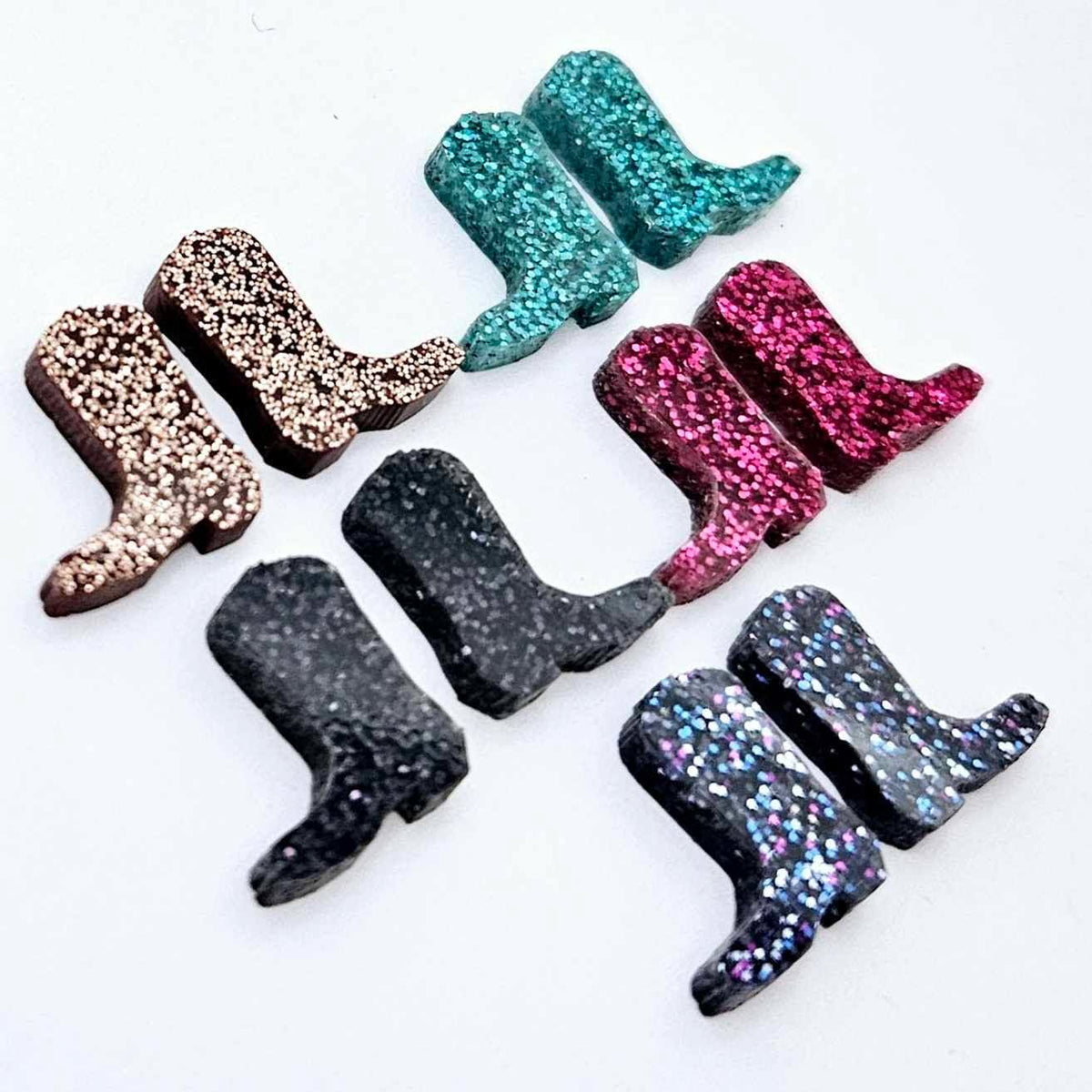 15mm glitter boot stud earring blanks in copper, black, holographic blue, hot pink and teal glitter, with one pair of each colour laid flat together.
