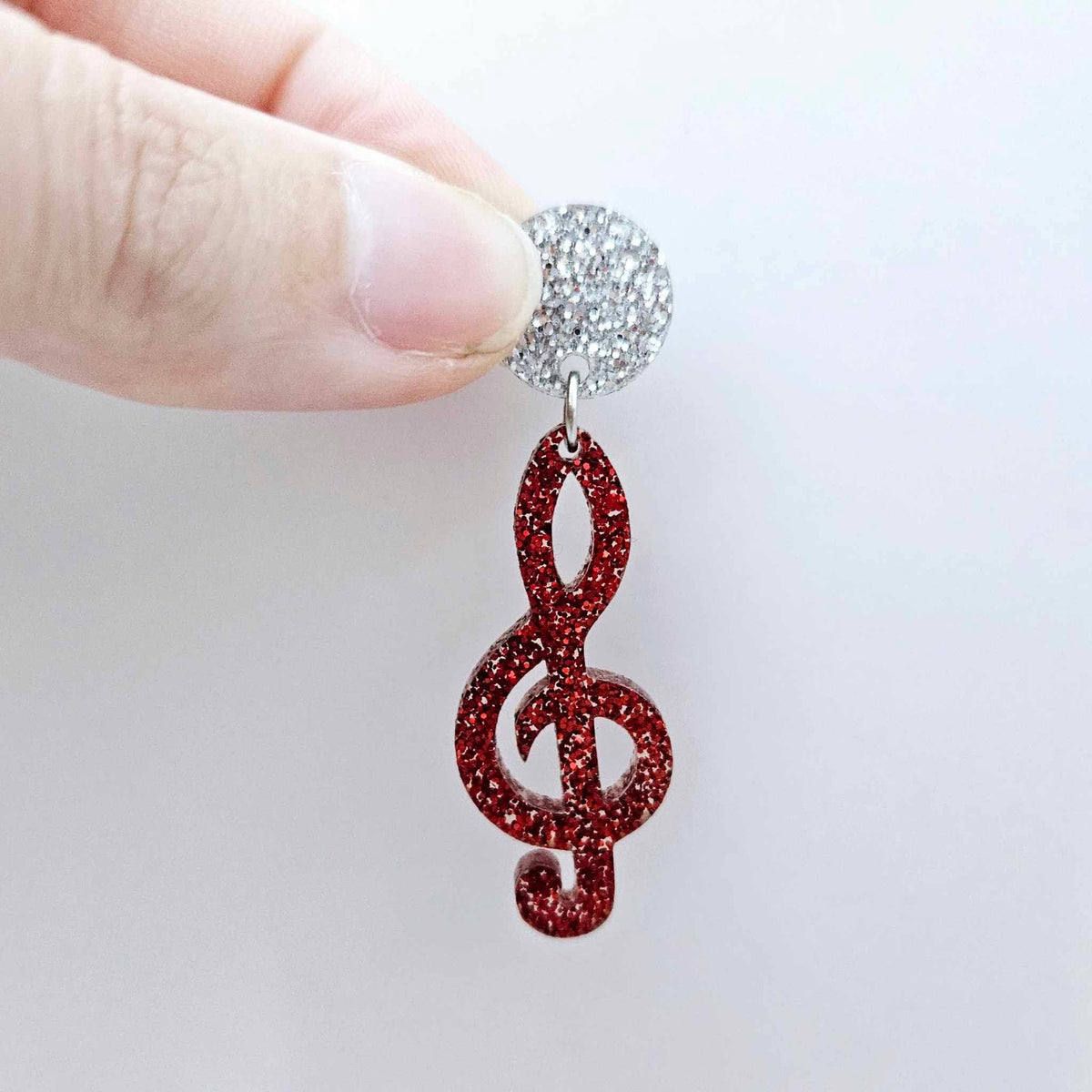 40mm red glitter treble clef earring dangle blank assembled with a 14mm silver glitter topper, showing how the pieces can be paired to create a finished music-inspired earring.