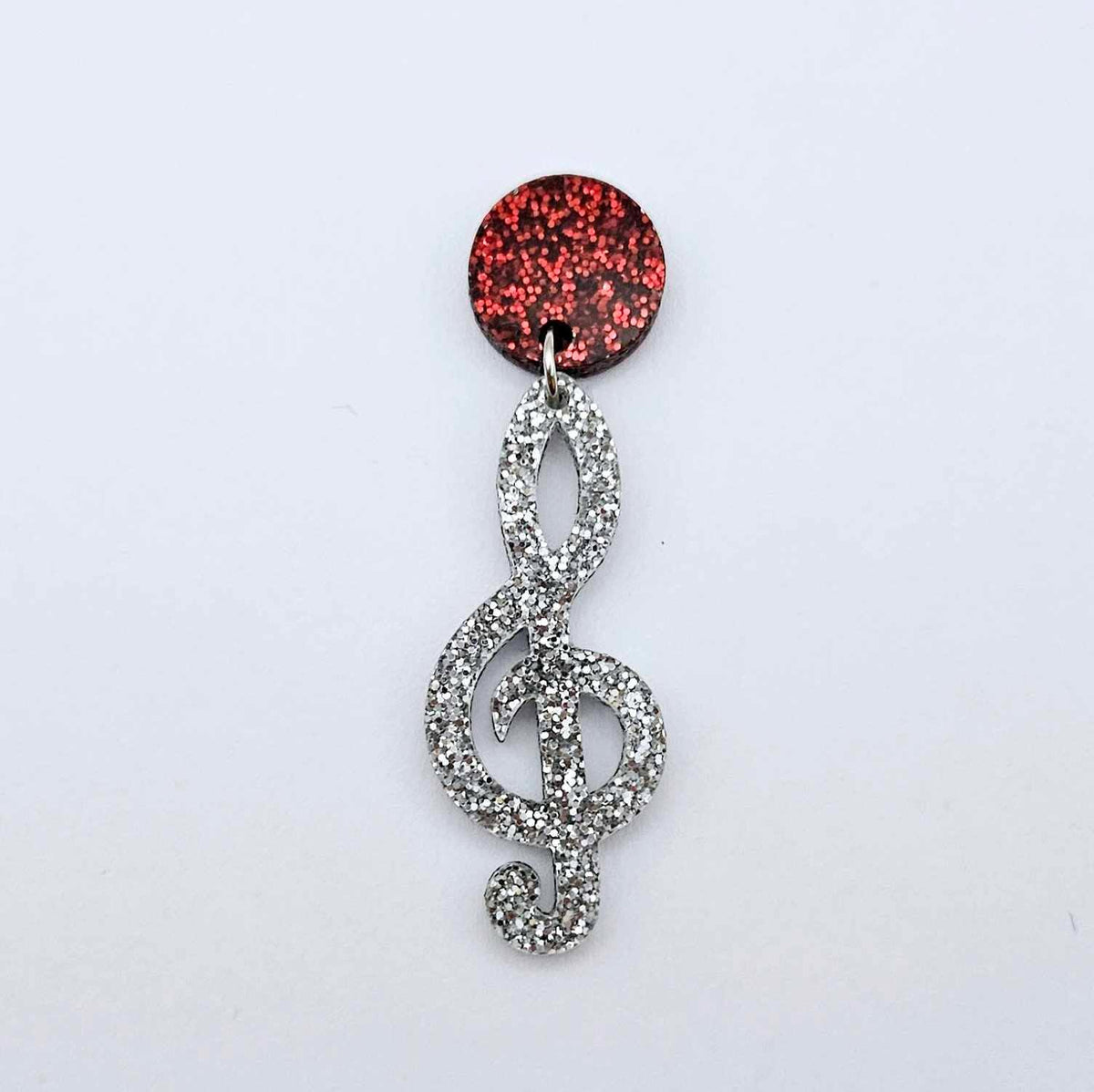 40mm silver glitter treble clef earring dangle blank assembled with a 14mm red glitter topper, showing how the pieces can be paired to create a finished music inspired earring.