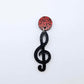 40mm holographic black glitter treble clef earring dangle blank assembled with a 14mm red glitter topper, showing how the pieces can be paired to create a finished music inspired earring.